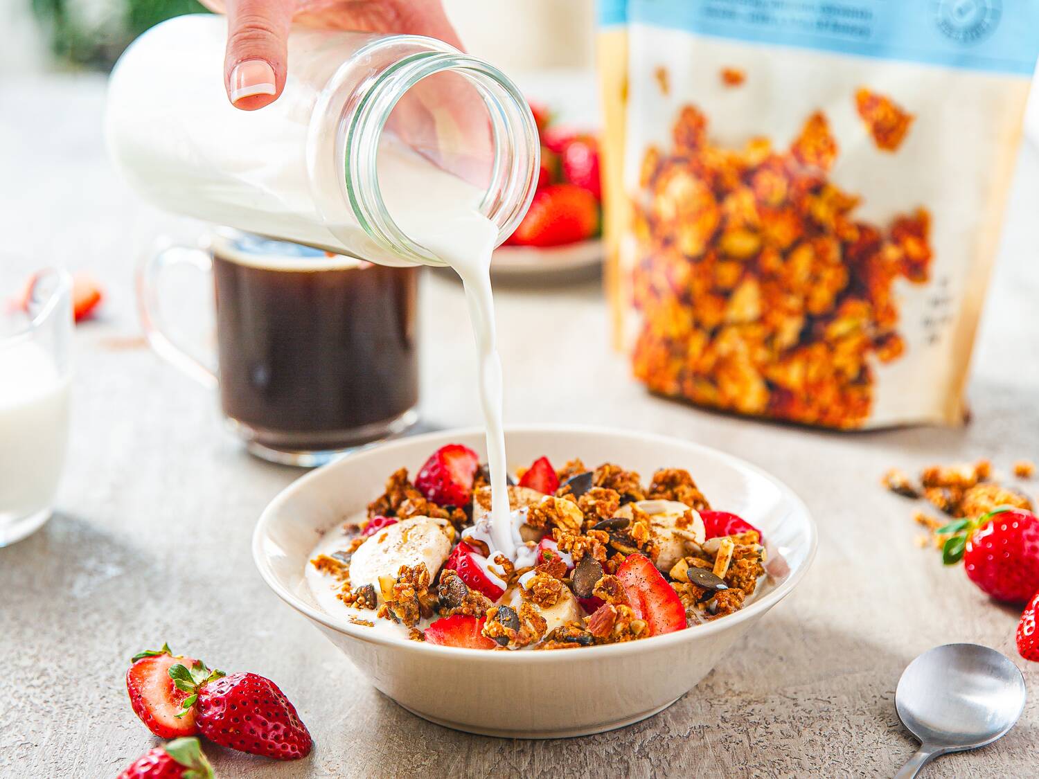 granola in cereal bowl with milk and pouch