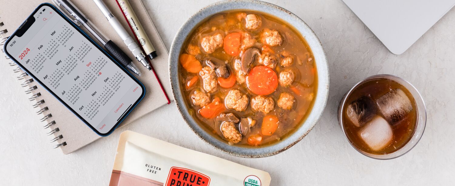 Beef and Mushroom Organic Soup in bowl next to pouch
