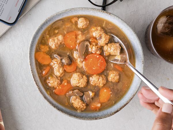 True Primal Beef & Mushroom Soup in bowl with spoon