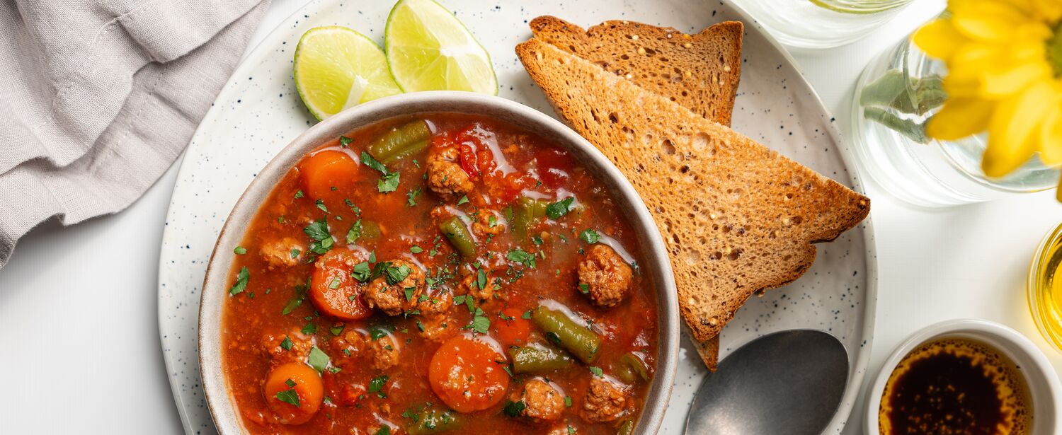 True Primal Beef & Mushroom Soup in bowl next to toast