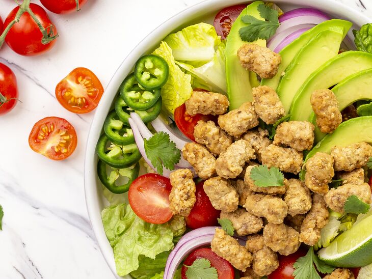 True Primal Grass-Fed Beef Mini Meatballs in bowl on salad next to vegetables