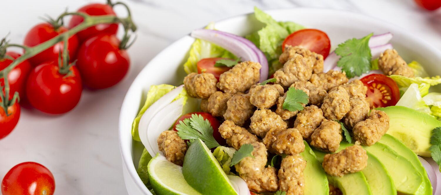 True Primal Grass fed Beef Mini Meatballs in a salad bowl closeup