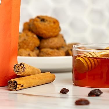 Ceylon cinnamon sticks and a jar of honey with Ona cookies