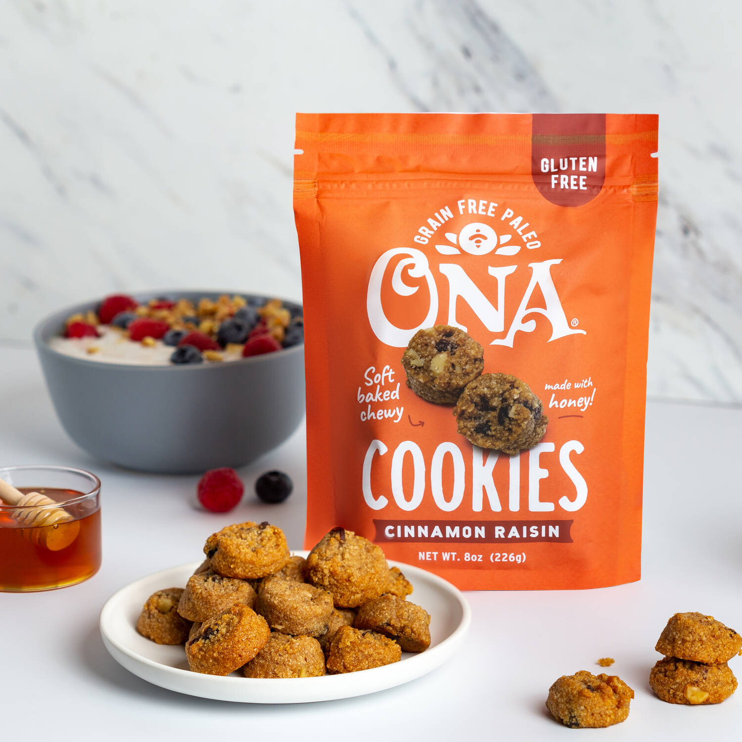 Ona Cinnamon Raisin Cookies with berries and honey dipper