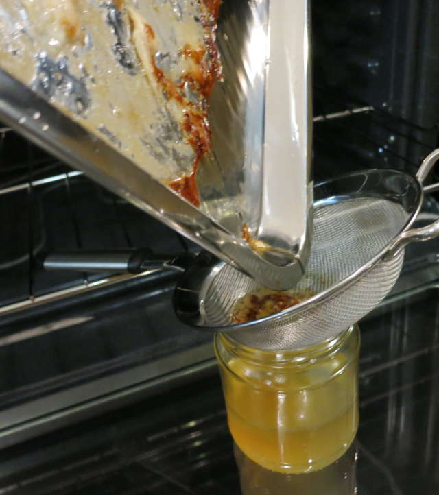 pouring bacon grease and drippings from pan into jar