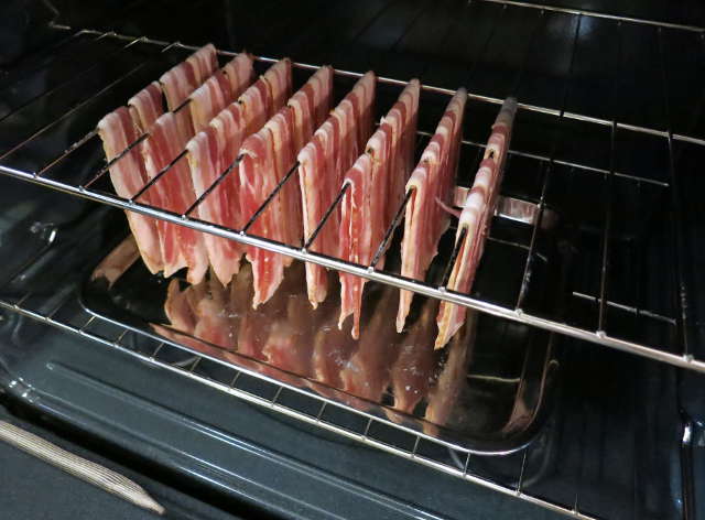 https://trueprimal.com/posts/baking_bacon/img/raw_bacon_hanging_from_oven_rack_pushed_back_inside.jpg